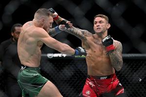 LAS VEGAS, NEVADA - JULY 10: Dustin Poirier (R) lands a punch on Conor McGregor of Ireland in the first round in their lightweight bout during UFC 264: Poirier v McGregor 3 at T-Mobile Arena on July 10, 2021 in Las Vegas, Nevada. (Getty Images)