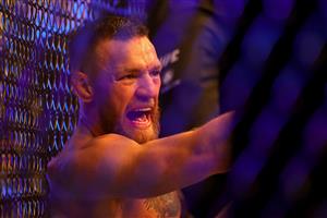 LAS VEGAS, NEVADA - JULY 10: Conor McGregor of Ireland sits on the mat after injuring his ankle in the first round in his lightweight bout against Dustin Poirier during UFC 264: Poirier v McGregor 3 at T-Mobile Arena on July 10, 2021 in Las Vegas, Nevada. (Getty Images)