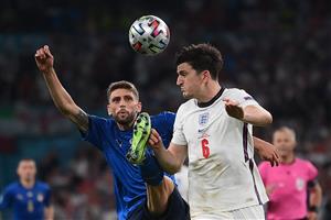 Italy's forward Domenico Berardi (L) vies for the ball with England's defender Harry Maguire during the UEFA EURO 2020 final football match between Italy and England at the Wembley Stadium in London on July 11, 2021. (Getty Images)