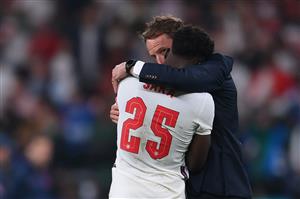 England's coach Gareth Southgate speaks to England's midfielder Bukayo Saka after their loss in the UEFA EURO 2020 final football match between Italy and England at the Wembley Stadium in London on July 11, 2021. (Getty Images)
