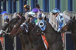 MELBOURNE, AUSTRALIA - JULY 10: Jamie Kah riding Red Santa out of the barriers before winning race 6, the Behind The Barriers Boxing Challenge 7/8, during Melbourne Racing at Caulfield Racecourse on July 10, 2021 in Melbourne, Australia. (Photo by Vince Caligiuri/Getty Images)