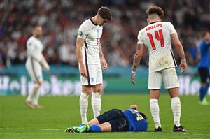 LONDON, ENGLAND - JULY 11: Federico Chiesa of Italy lies injured as John Stones and Kalvin Phillips of England check on him during the UEFA Euro 2020 Championship Final between Italy and England at Wembley Stadium on July 11, 2021 in London, England. (Getty Images)
