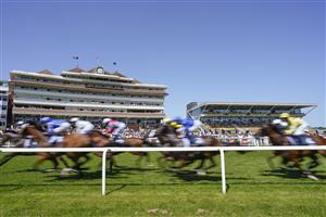 NEWBURY, ENGLAND - JULY 17: A general view as runners pass the grandstands with a circuit to go in The Bahrain Turf Series Handicap at Newbury Racecourse on July 17, 2021 in Newbury, England. Due to the Coronavirus pandemic, only owners along with a limited number of the paying public will be allowed to attend the meeting. (Photo by Alan Crowhurst/Getty Images)