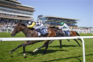 NEWBURY, ENGLAND - JULY 17: Silvestre De Sousa riding Scaramanga (L) win The Bahrain Turf Series Handicap at Newbury Racecourse on July 17, 2021 in Newbury, England. Due to the Coronavirus pandemic, only owners along with a limited number of the paying public will be allowed to attend the meeting. (Photo by Alan Crowhurst/Getty Images)