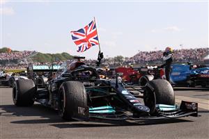 TOPSHOT - Mercedes' British driver Lewis Hamilton celebrates after winning the Formula One British Grand Prix motor race at Silverstone motor racing circuit in Silverstone, central England on July 18, 2021. (Getty Images)