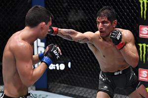 LAS VEGAS, NEVADA - JULY 17: In this handout photo provided by UFC, (R-L) Gabriel Benitez of Mexico punches Billy Quarantillo in their featherweight bout during the UFC Fight Night event at UFC APEX on July 17, 2021 in Las Vegas, Nevada. (Getty Images)