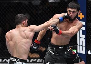 LAS VEGAS, NEVADA - JULY 17: In this handout photo provided by UFC, (L-R) Thiago Moises of Brazil punches Islam Makhachev of Russia in their lightweight bout during the UFC Fight Night event at UFC APEX on July 17, 2021 in Las Vegas, Nevada. (Getty Images)