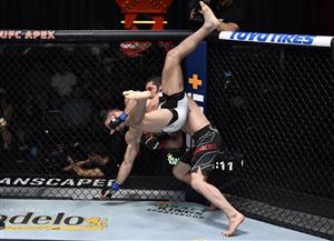 LAS VEGAS, NEVADA - JULY 17: In this handout photo provided by UFC, (R-L) Islam Makhachev of Russia takes down Thiago Moises of Brazil in their lightweight bout during the UFC Fight Night event at UFC APEX on July 17, 2021 in Las Vegas, Nevada. (Getty Images)
