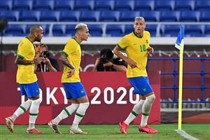 Brazil's forward Richarlison (R) celebrates with Brazil's forward Antony (C) and Brazil's defender Dani Alves after scoring his side's second goal during the Tokyo 2020 Olympic Games men's group D first round football match between Brazil and Germany at the Yokohama International Stadium in Yokohama on July 22, (Getty Images)