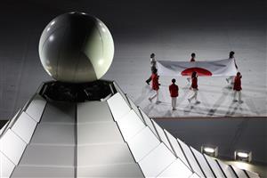 TOKYO, JAPAN - JULY 23: The Japanese flag is carried past the Olympic cauldron during the Opening Ceremony of the Tokyo 2020 Olympic Games at Olympic Stadium on July 23, 2021 in Tokyo, Japan. (Getty Images)
