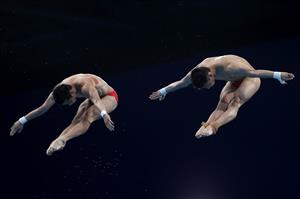 TOKYO, JAPAN - JULY 26: Yuan Cao and Aisen Chen of Team China compete during the Men's Synchronised 10m Platform Final on day three of the Tokyo 2020 Olympic Games at Tokyo Aquatics Centre on July 26, 2021 in Tokyo, Japan. (Getty Images)
