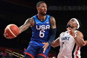 USA's Damian Lillard (L) tries to pass the past France's Guerschon Yabusele during the men's preliminary round group A basketball match between France and USA during the Tokyo 2020 Olympic Games at the Saitama Super Arena in Saitama on July 25, 2021. (Getty Images)