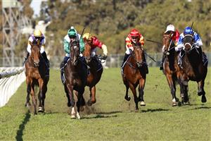 SYDNEY, AUSTRALIA - JULY 24: Tim Clark on Silent Impact (green/white) wins race 1 the Elite Sand & Soil Handicap during Sydney Racing at Rosehill Gardens on July 24, 2021 in Sydney, Australia. (Photo by Mark Evans/Getty Images)