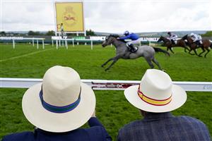 CHICHESTER, ENGLAND - JULY 27: Two gentlemen watch the racing wearing Panama hats during the Qatar Goodwood Festival at Goodwood Racecourse on July 27, 2021 in Chichester, England. (Photo by Alan Crowhurst/Getty Images)