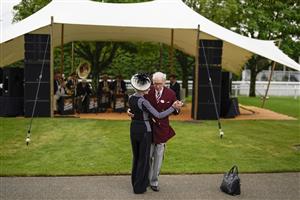 CHICHESTER, ENGLAND - JULY 27: A couple dance as the band plays on during the Qatar Goodwood Festival at Goodwood Racecourse on July 27, 2021 in Chichester, England. (Photo by Alan Crowhurst/Getty Images)