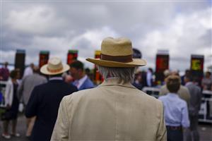 CHICHESTER, ENGLAND - JULY 27: Eyeing up the odds during the Qatar Goodwood Festival at Goodwood Racecourse on July 27, 2021 in Chichester, England. (Photo by Alan Crowhurst/Getty Images)