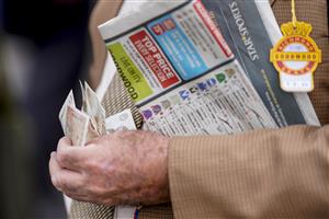 CHICHESTER, ENGLAND - JULY 27: Cash at the ready during the Qatar Goodwood Festival at Goodwood Racecourse on July 27, 2021 in Chichester, England. (Photo by Alan Crowhurst/Getty Images)