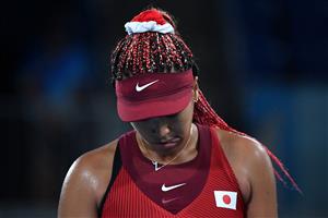 Naomi Osaka appears dejected after losing to Marketa Vondrousova in the women's Olympic tennis tournament. (Getty Images)