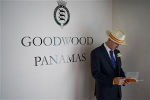 CHICHESTER, ENGLAND - JULY 28: A racegoers checks the racecard during the Qatar Goodwood Festival at Goodwood Racecourse on July 28, 2021 in Chichester, England. (Photo by Alan Crowhurst/Getty Images)