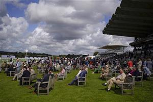 CHICHESTER, ENGLAND - JULY 28: Racegoers relax on the lawn during the Qatar Goodwood Festival at Goodwood Racecourse on July 28, 2021 in Chichester, England. (Photo by Alan Crowhurst/Getty Images)