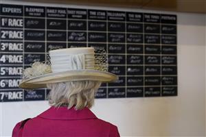CHICHESTER, ENGLAND - JULY 28: A racegoer checks out the selections board from the tipsters during the Qatar Goodwood Festival at Goodwood Racecourse on July 28, 2021 in Chichester, England. (Photo by Alan Crowhurst/Getty Images)