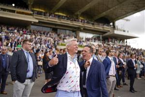 CHICHESTER, ENGLAND - JULY 28: Two racegoers share the delight of a winner during the Qatar Goodwood Festival at Goodwood Racecourse on July 28, 2021 in Chichester, England. (Photo by Alan Crowhurst/Getty Images)