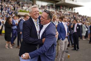 CHICHESTER, ENGLAND - JULY 28: Two racegoers share the delight of a winner during the Qatar Goodwood Festival at Goodwood Racecourse on July 28, 2021 in Chichester, England. (Photo by Alan Crowhurst/Getty Images)