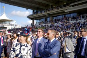 CHICHESTER, ENGLAND - JULY 29: A racegoer keeps an eye on the big screen during the race during the Qatar Goodwood Festival at Goodwood Racecourse on July 29, 2021 in Chichester, England. (Photo by Alan Crowhurst/Getty Images)