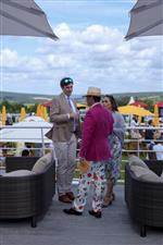CHICHESTER, ENGLAND - JULY 29: Enjoying the Champagne Bar during the Qatar Goodwood Festival at Goodwood Racecourse on July 29, 2021 in Chichester, England. (Photo by Alan Crowhurst/Getty Images)