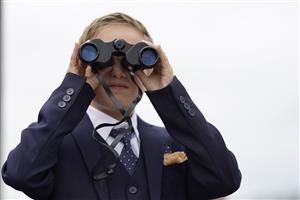 CHICHESTER, ENGLAND - JULY 31: A young racegoer with binoculars during the Qatar Goodwood Festival at Goodwood Racecourse on July 31, 2021 in Chichester, England. (Photo by Alan Crowhurst/Getty Images)