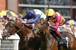 NEWBURY, ENGLAND - AUGUST 14: William Buick riding Masekela (farside) win The Academy Insurance British EBF Maiden Stakes from David Egan and Bayside Boy (nearest) at Newbury Racecourse on August 14, 2021 in Newbury, England. (Photo by Alan Crowhurst/Getty Images)