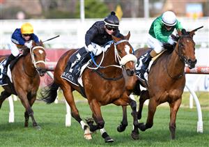 MELBOURNE, AUSTRALIA - AUGUST 14: Jamie Kah riding Gimmie Par winning Race 7, the Beck Probuild Quezette Stakes, during Melbourne Racing at Caulfield Racecourse on August 14, 2021 in Melbourne, Australia. (Photo by Vince Caligiuri/Getty Images)