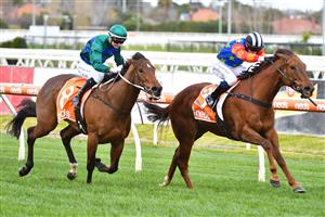 MELBOURNE, AUSTRALIA - AUGUST 14: Josh Richards riding Bella Nipotina defeats Jamie Kah riding Parlophone in Race 4, the Mark Mazzaglia Handicap, during Melbourne Racing at Caulfield Racecourse on August 14, 2021 in Melbourne, Australia. (Photo by Vince Caligiuri/Getty Images)