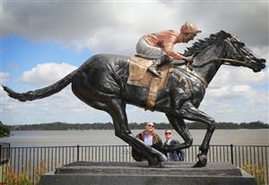 MELBOURNE, AUSTRALIA - OCTOBER 24: Trainer Peter Moody and jockey Luke Nolen look at the statue after the unveiling of the Black Caviar statue on October 24, 2013 in Nagambie, Victoria, Australia. Black Caviar is an Australian Thoroughbred racehorse undefeated in 25 races, a success record not equalled for over 100 years. The statue was unveiled in the Victorian country town of Nagambie, where she was born. (Photo by Scott Barbour/Getty Images)