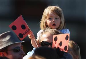 SYDNEY, AUSTRALIA - APRIL 09: A young race goer supporting Black Caviar waits for the start of race five the Darley T J Smith Stakes on AJC Australian Derby Day at Royal Randwick Racecourse on April 9, 2011 in Sydney, Australia. (Photo by Mark Kolbe/Getty Images)