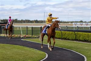 KEMBLA GRANGE, AUSTRALIA - AUGUST 28: James McDonald on Royalzel points as he returns to scale after winning
race 2 the Midway Handicap during Sydney Racing at Kembla Grange Racecourse on August 28, 2021 in Kembla Grange, Australia. (Photo by Mark Evans/Getty Images)