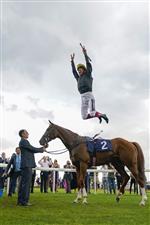 DONCASTER, ENGLAND - SEPTEMBER 10: Frankie Dettori leaps from his mount in the winners enclosure after riding Stradivarius to win The Doncaster Cup Stakes at Doncaster Racecourse on September 10, 2021 in Doncaster, England. (Photo by Alan Crowhurst/Getty Images)