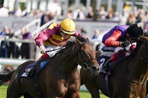 DONCASTER, ENGLAND - SEPTEMBER 11: David Egan riding Bayside Boy (L, yellow cap) win The Champagne Stakes from Frankie Dettori and Reach For The Moon (black cap) at Doncaster Racecourse on September 11, 2021 in Doncaster, England. (Photo by Alan Crowhurst/Getty Images)
