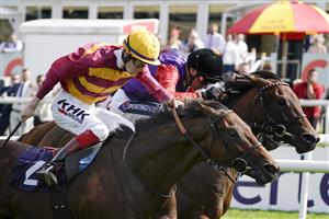 DONCASTER, ENGLAND - SEPTEMBER 11: David Egan riding Bayside Boy (L, yellow cap) win The Champagne Stakes from Frankie Dettori and Reach For The Moon (black cap) at Doncaster Racecourse on September 11, 2021 in Doncaster, England. (Photo by Alan Crowhurst/Getty Images)