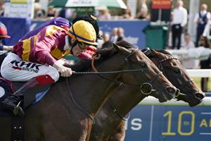 DONCASTER, ENGLAND - SEPTEMBER 11: David Egan riding Bayside Boy (L, yellow cap) win The Champagne Stakes from Frankie Dettori and Reach For The Moon (black cap) at Doncaster Racecourse on September 11, 2021 in Doncaster, England. (Photo by Alan Crowhurst/Getty Images)