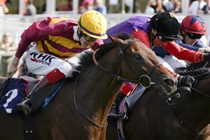 DONCASTER, ENGLAND - SEPTEMBER 11: David Egan riding Bayside Boy (L, yellow cap) win The Champagne Stakes from Frankie Dettori and Reach For The Moon (black cap) at Doncaster Racecourse on September 11, 2021 in Doncaster, England. (Photo by Alan Crowhurst/Getty Images)