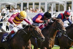 DONCASTER, ENGLAND - SEPTEMBER 11: David Egan riding Bayside Boy (L, yellow cap) win The Champagne Stakes from Frankie Dettori and Reach For The Moon (black cap) at Doncaster Racecourse on September 11, 2021 in Doncaster, England. (Photo by Alan Crowhurst/Getty Images)