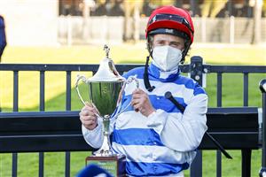 KEMBLA GRANGE, AUSTRALIA - SEPTEMBER 11: Brock Ryan holds up his trophy after winning race 7 The Chandon Theo Marks Stakes on Chat during Sydney Racing at Kembla Grange Racecourse on September 11, 2021 in Kembla Grange, Australia. (Photo by Mark Evans/Getty Images)