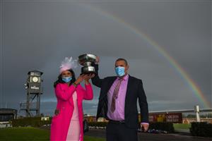 MELBOURNE, AUSTRALIA - SEPTEMBER 18: Trainers Natalie Young and Trent Busuttin pose with the trophy after Sierra Sue won Race 8, the Neds Sir Rupert Clarke Stakes, during Melbourne Racing at Caulfield Racecourse on September 18, 2021 in Melbourne, Australia. (Photo by Vince Caligiuri/Getty Images)