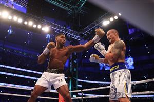 LONDON, ENGLAND - SEPTEMBER 25: Anthony Joshua punches as Oleksandr Usyk looks on during the Heavyweight Title Fight between Anthony Joshua and Oleksandr Usyk at Tottenham Hotspur Stadium on September 25, 2021 in London, England. (Getty Images)