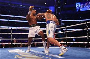LONDON, ENGLAND - SEPTEMBER 25: Anthony Joshua looks on as Oleksandr Usyk punches during the Heavyweight Title Fight between Anthony Joshua and Oleksandr Usyk at Tottenham Hotspur Stadium on September 25, 2021 in London, England. (Getty Images)