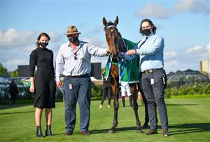 MELBOURNE, AUSTRALIA - OCTOBER 02: Katherine Coleman and Peter Moody pose with Incentivise after winning Race 7, the Tab Turnbull Stakes, during Melbourne Racing at Flemington Racecourse on October 02, 2021 in Melbourne, Australia. (Photo by Vince Caligiuri/Getty Images)