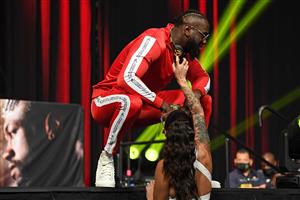 US boxer Deontay Wilder is sprayed cologne by his fiance Telli Swift as he attends a press conference with British boxer Tyson Fury (out of frame) for their WBC heavyweight championship fight, October 6, 2021 at the MGM Grand Garden Arena in Las Vegas, Nevada ahead of their October 9, 2021 fight. (Getty Images)