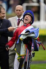 NEWMARKET, ENGLAND - OCTOBER 08: Frankie Dettori shares a joke with journalists after riding Inspiral to win The bet365 Fillies' Mile at Newmarket Racecourse on October 08, 2021 in Newmarket, England. (Photo by Alan Crowhurst/Getty Images)
