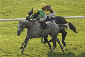 NEWMARKET, ENGLAND - OCTOBER 09: Oisin Murphy riding Buzz (green) win The Together For Racing International Cesarewitch Handicap at Newmarket Racecourse on October 09, 2021 in Newmarket, England. (Photo by Alan Crowhurst/Getty Images)
